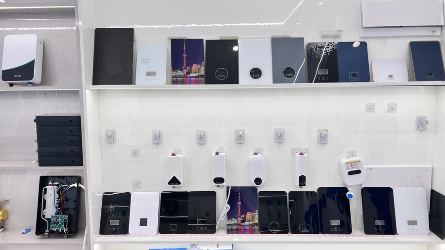 Instant water heater models arranged on showroom shelving